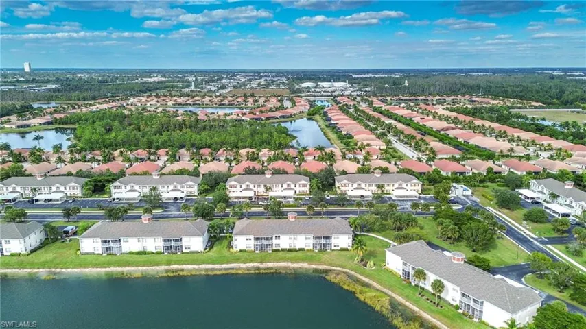 Aerial view of property's location with a nearby body of water and nearby suburban area