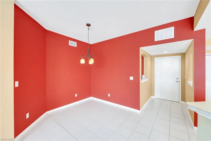 Empty room featuring baseboards and light tile patterned floors
