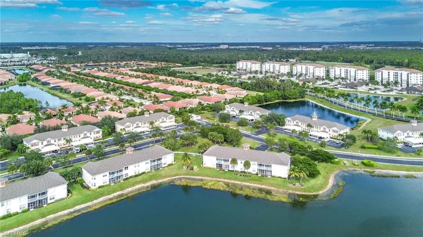 Aerial view of property and surrounding area featuring a large body of water