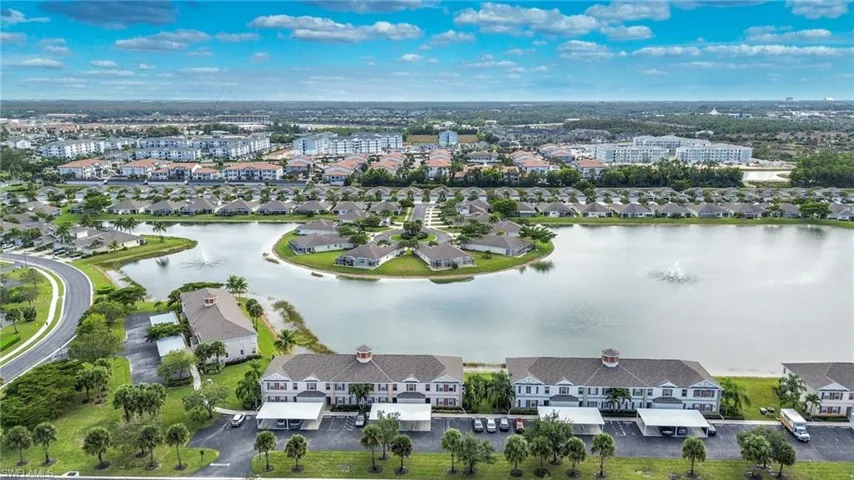 Aerial view of residential area featuring a nearby body of water