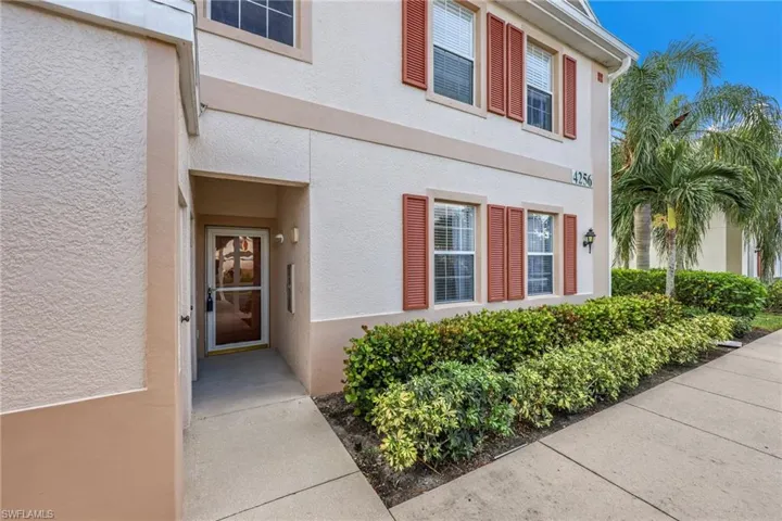Doorway to property featuring stucco siding
