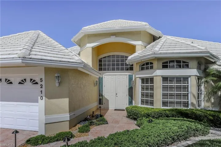 Doorway to property with a garage