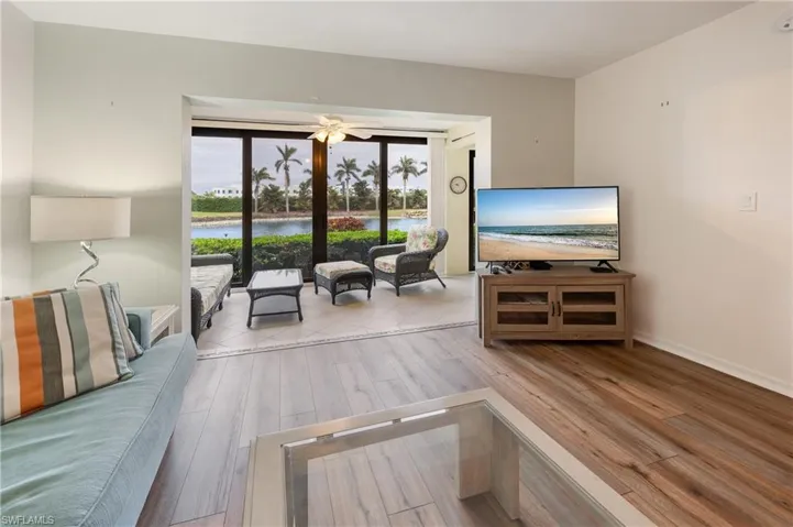 Living room featuring light wood-type flooring and ceiling fan