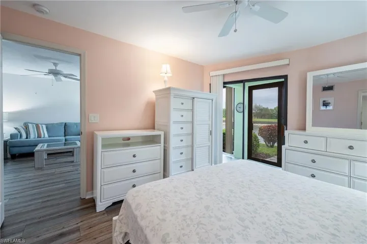 Bedroom featuring dark hardwood / wood-style floors, ceiling fan, and access to outside