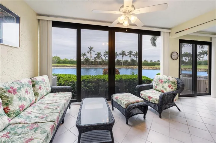 Sunroom / solarium featuring plenty of natural light, a water view, and ceiling fan