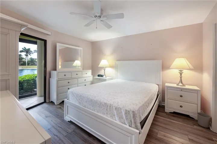 Bedroom featuring ceiling fan, access to outside, and dark wood-type flooring