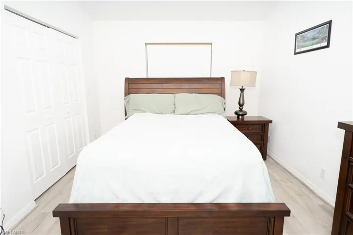 Bedroom featuring light wood-style flooring and a closet