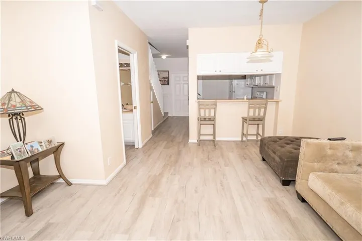 Living area featuring light wood-style flooring and baseboards