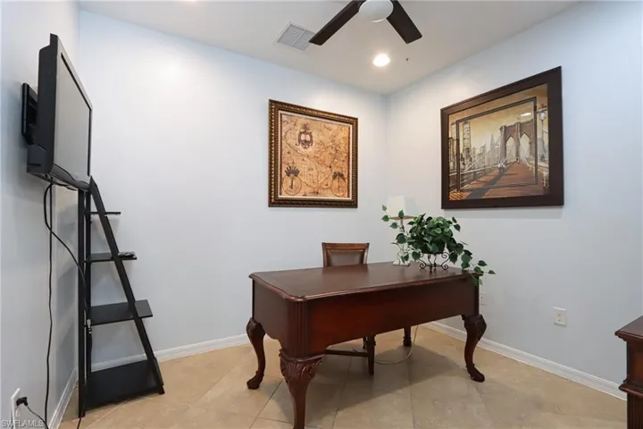 Tiled office featuring ceiling fan