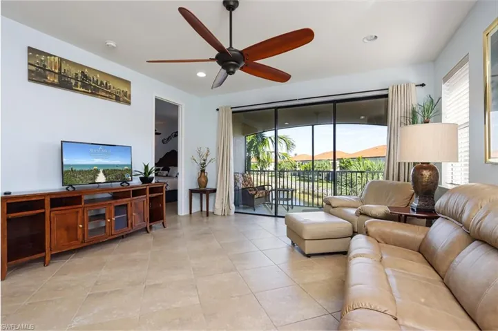 Tiled living room featuring ceiling fan