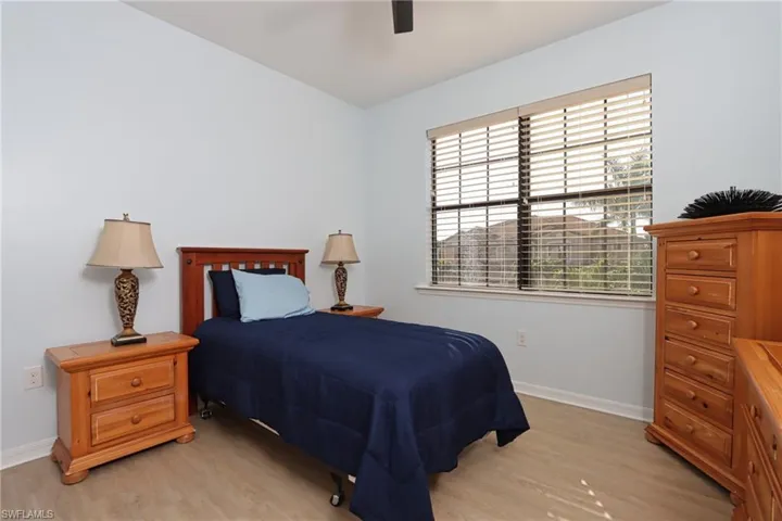 Bedroom with ceiling fan and light wood-type flooring