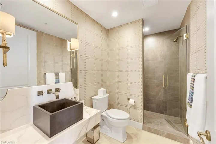 Beautifully appointed guest bathroom with walk-in shower, elegant vanity and walk in shower.