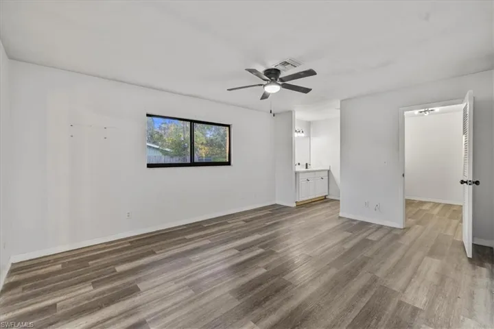 Unfurnished room with hardwood / wood-style flooring and ceiling fan