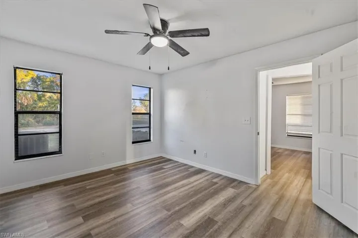 Spare room with ceiling fan and light wood-type flooring