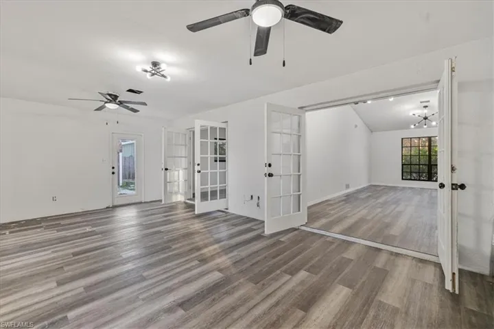Unfurnished living room with hardwood / wood-style floors, french doors, and ceiling fan
