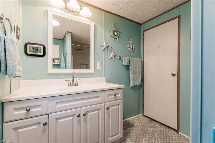 Bathroom with vanity, spa colors and tile patterned floors