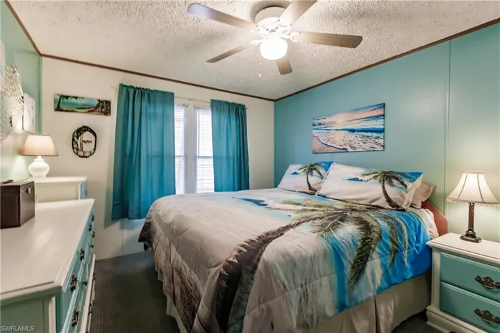 Stay extra cool with  ceiling fan/light, Note  ornamental molding and Berber carpet.