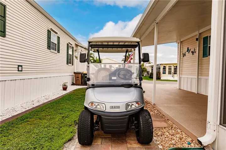 View of patio with golf cart parking