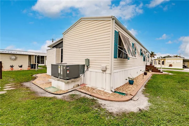 View of home's exterior featuring a yard and central air condition unit