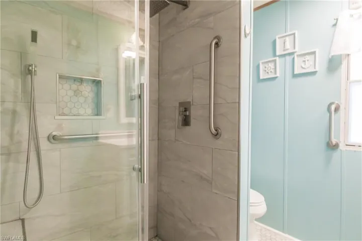 Bathroom with a custom tile enclosed shower and rainfall shower head