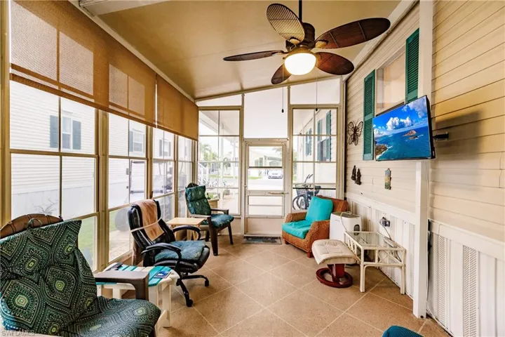 Screened lanai featuring TV, ceiling fan and lofted ceiling