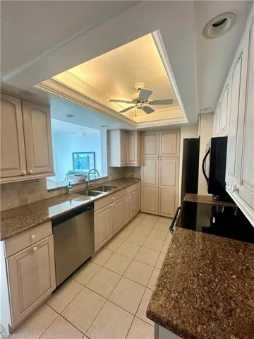 Dining space featuring light tile patterned flooring, a textured ceiling, and baseboards