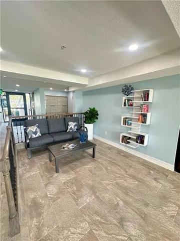Half bathroom with baseboards, visible vents, toilet, and a textured ceiling