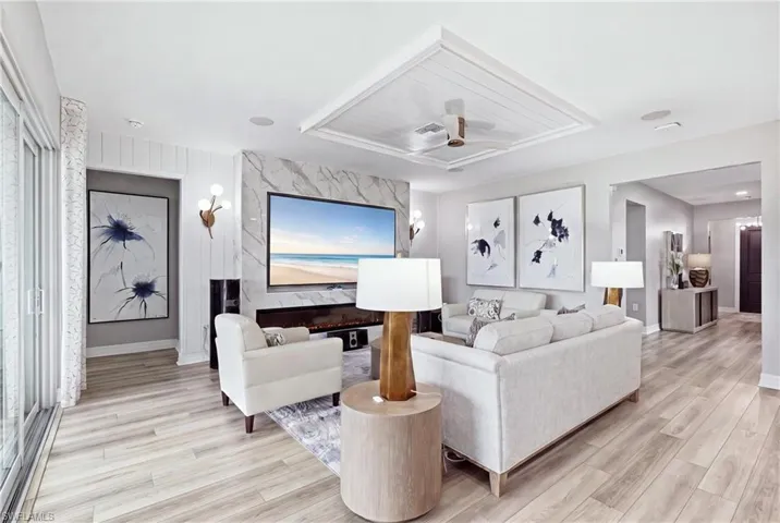 Open-concept living highlighted by a customer tray ceiling and designer finishes