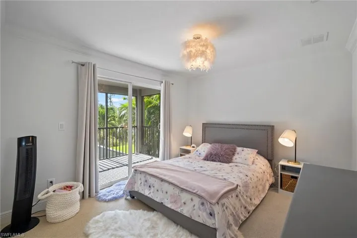 Bedroom featuring crown molding, access to outside, and carpet floors