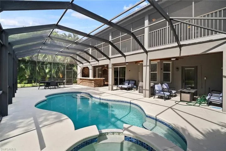 View of swimming pool featuring an in ground hot tub, a patio, ceiling fan, a lanai, and an outdoor hangout area