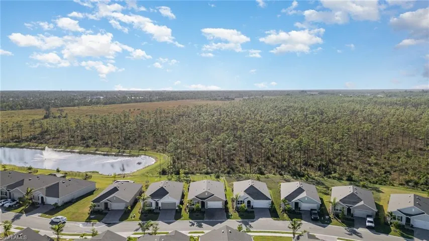 Birds eye view of property with a water view