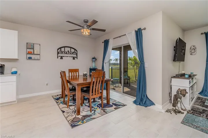 Dining room featuring plank tile flooring and ceiling fan light