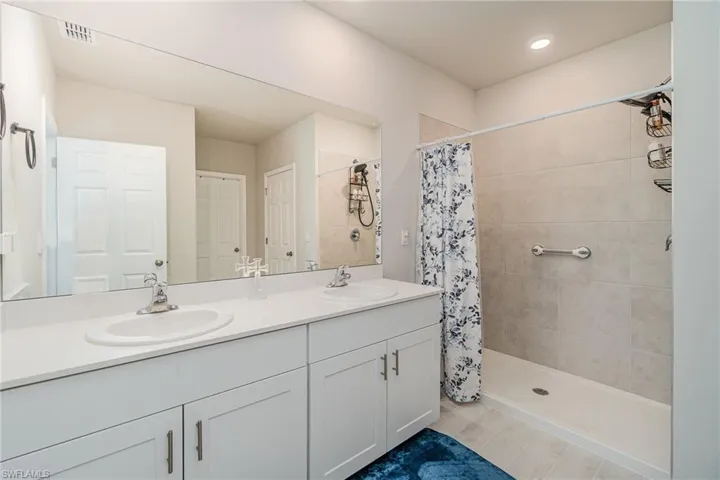 Bathroom featuring vanity and curtained shower
