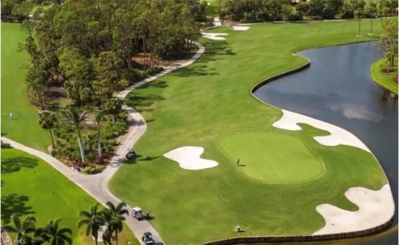 View of community with a water view, view of golf course, and view of scattered trees