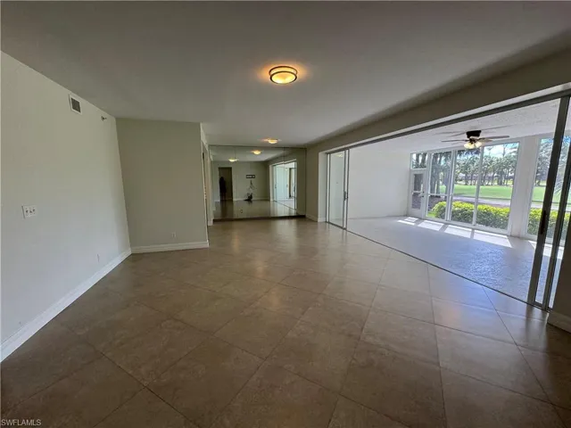 Unfurnished room with ceiling fan and baseboards