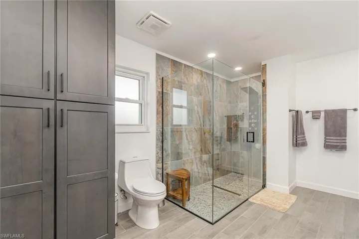 Bathroom with toilet and an enclosed glass shower