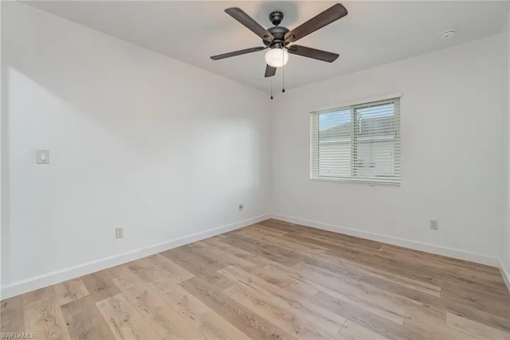 Spare room featuring ceiling fan and light wood-type flooring