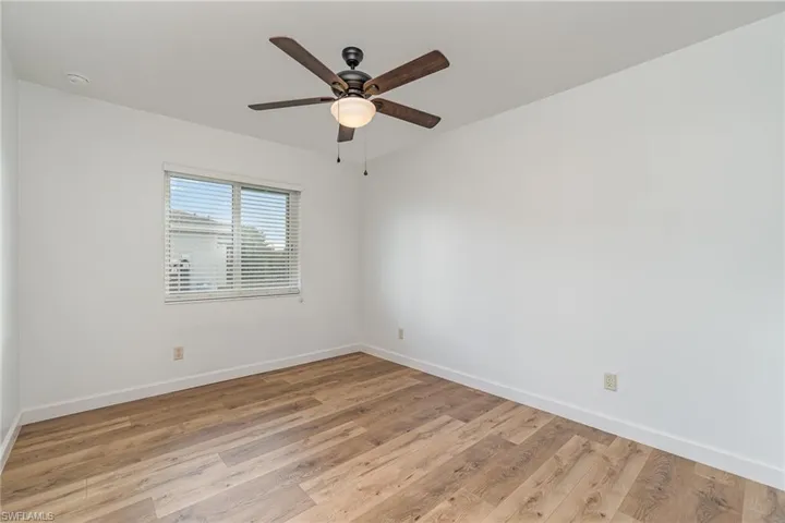 Unfurnished room with light wood-type flooring and ceiling fan