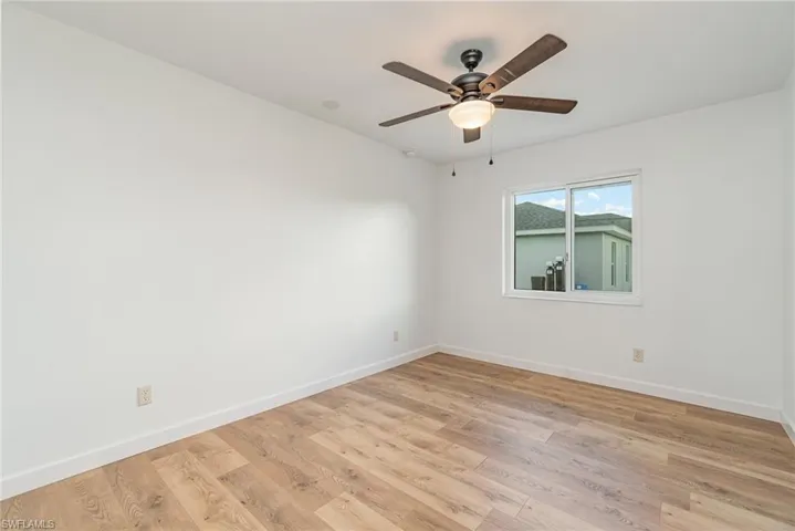 Spare room featuring ceiling fan and light hardwood / wood-style floors