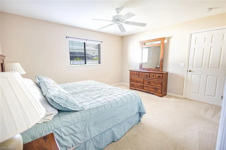 Carpeted bedroom with ceiling fan