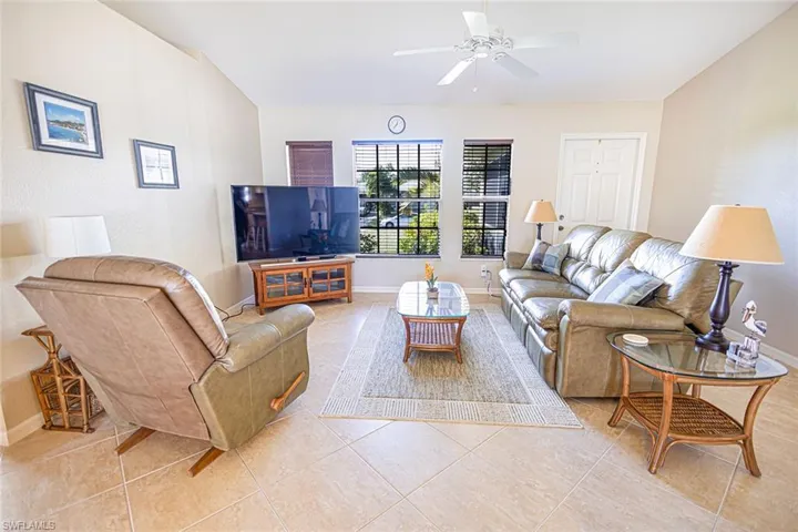 Living room featuring ceiling fan and light tile patterned floors