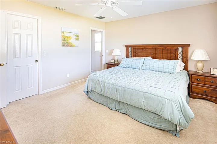 Bedroom featuring light colored carpet and ceiling fan