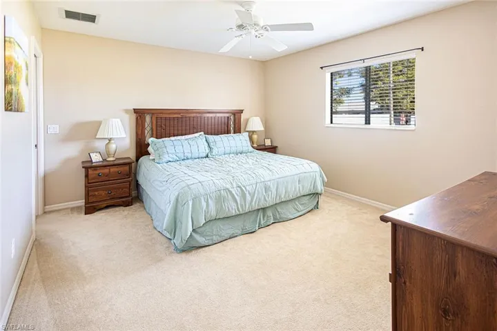 Bedroom with light carpet and ceiling fan