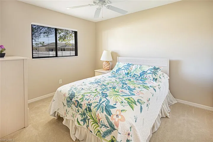 Carpeted bedroom with ceiling fan