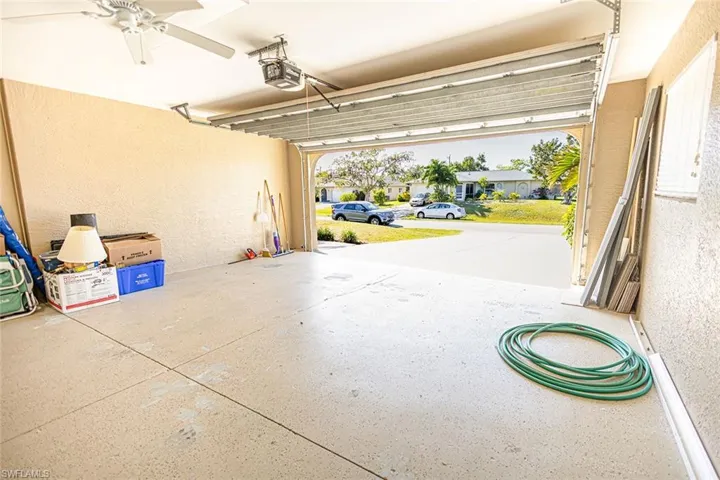 Garage with ceiling fan and a garage door opener