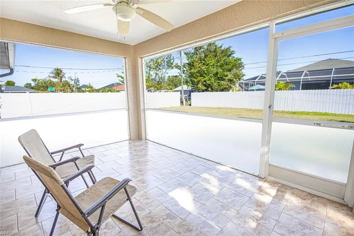 Unfurnished sunroom with ceiling fan