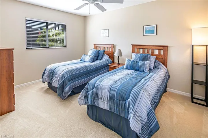 Carpeted bedroom featuring ceiling fan