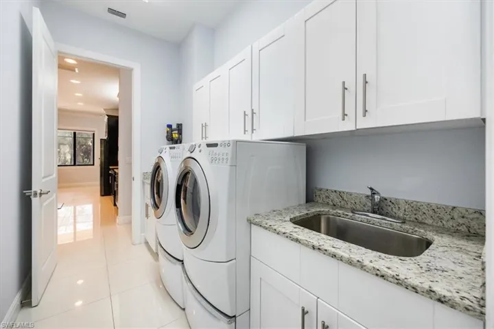 Laundry room with sink and cabinets