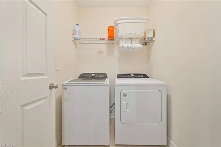 Washroom with washer and clothes dryer