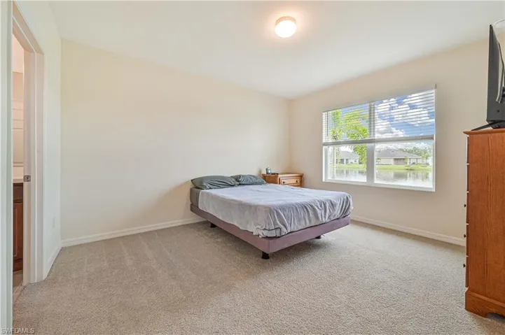 Bedroom with light colored carpet
